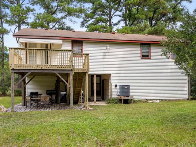 back of property with a deck, a lawn, cooling unit, and stairs