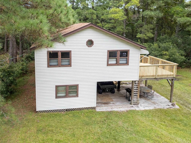 exterior space featuring a deck, a yard, and outdoor dining space