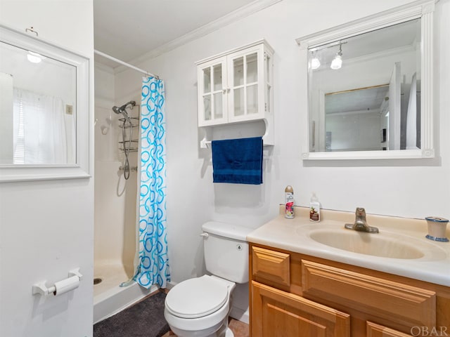 bathroom featuring a stall shower, crown molding, vanity, and toilet