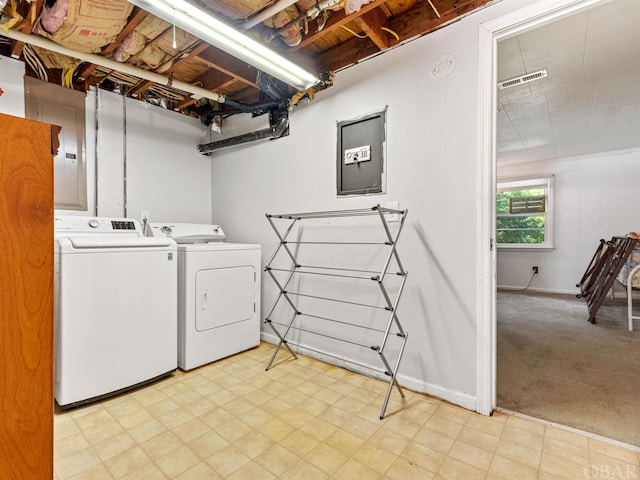 laundry room featuring light colored carpet, laundry area, visible vents, light floors, and washer and clothes dryer