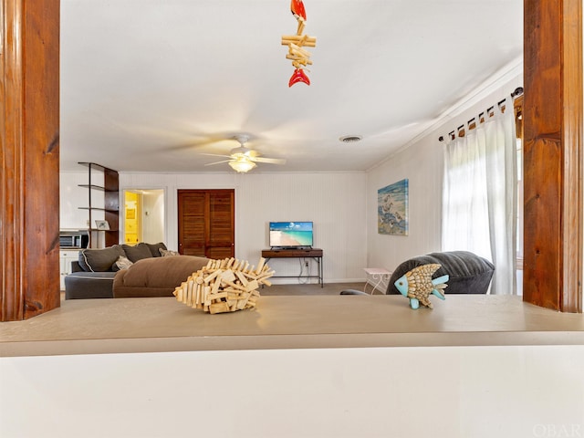 living area featuring a ceiling fan