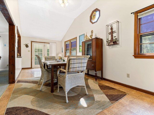 dining space featuring vaulted ceiling, french doors, and baseboards