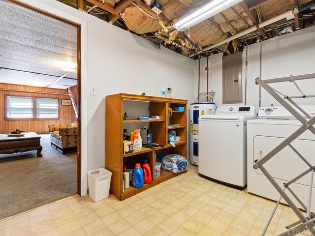 washroom with light colored carpet, wood walls, washer and dryer, water heater, and light floors