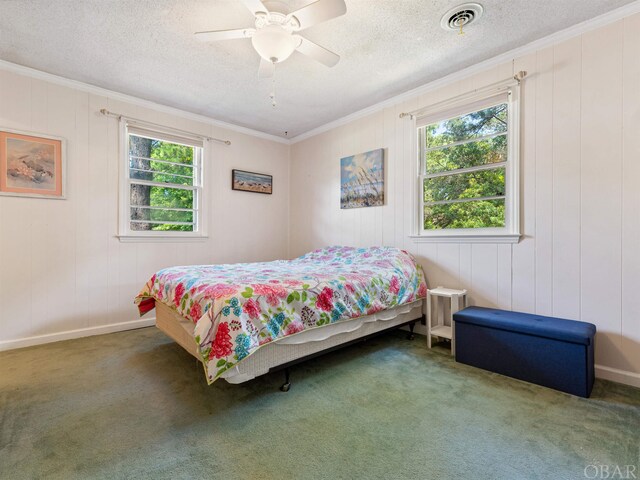 bedroom featuring carpet, visible vents, crown molding, and multiple windows