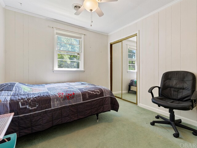 bedroom featuring a closet, carpet, visible vents, and crown molding