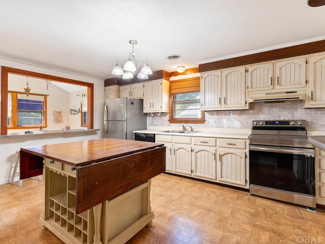 2381 Swan Island Rd Lot # 16, Corolla, NC 27927 - kitchen featuring under cabinet range hood, stainless steel appliances, hanging light fixtures, backsplash, and open shelves