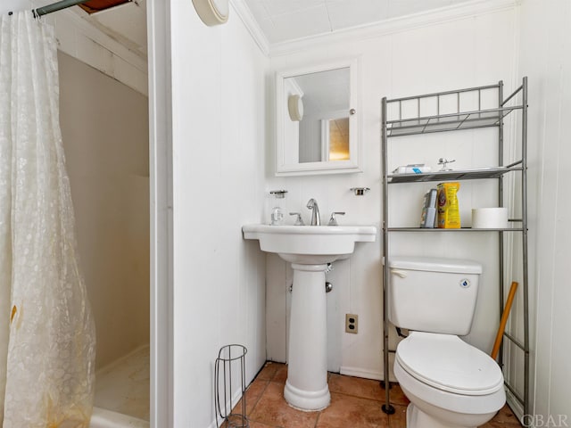 full bath with toilet, a stall shower, crown molding, and tile patterned floors