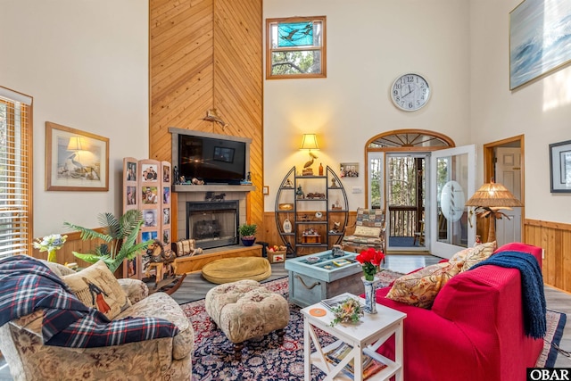 119 Baycliff Trl Lot 119, Kill Devil Hills, NC 27948 - living area featuring a towering ceiling, healthy amount of natural light, wood walls, a large fireplace, and wood finished floors