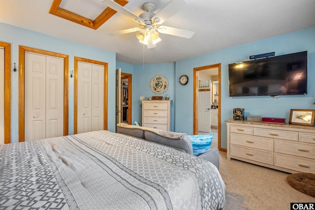 119 Baycliff Trl Lot 119, Kill Devil Hills, NC 27948 - bedroom featuring light carpet, two closets, a ceiling fan, and ensuite bath