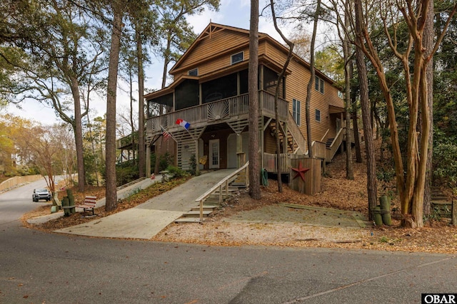 119 Baycliff Trl Lot 119, Kill Devil Hills, NC 27948 - view of front of property with stairway, a sunroom, and a wooden deck