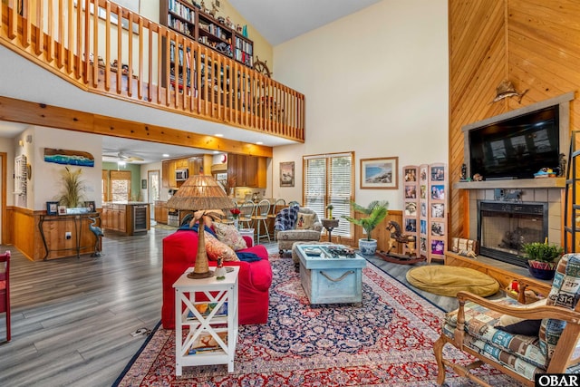 119 Baycliff Trl Lot 119, Kill Devil Hills, NC 27948 - living area with a fireplace, high vaulted ceiling, wood finished floors, wooden walls, and a ceiling fan