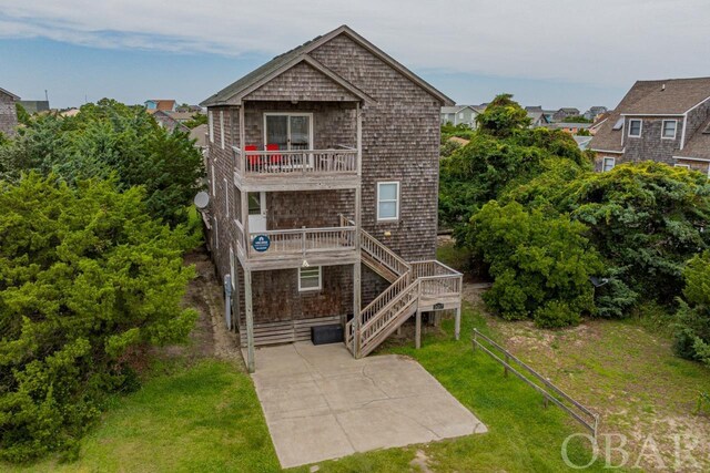 back of house featuring a patio, a yard, stairway, and a balcony