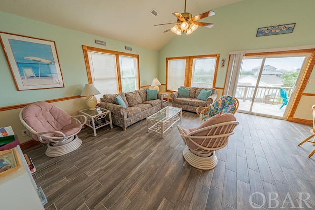 living area with high vaulted ceiling, visible vents, dark wood finished floors, and a ceiling fan