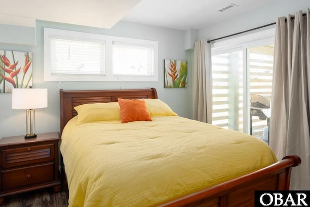 bedroom with wood finished floors and visible vents