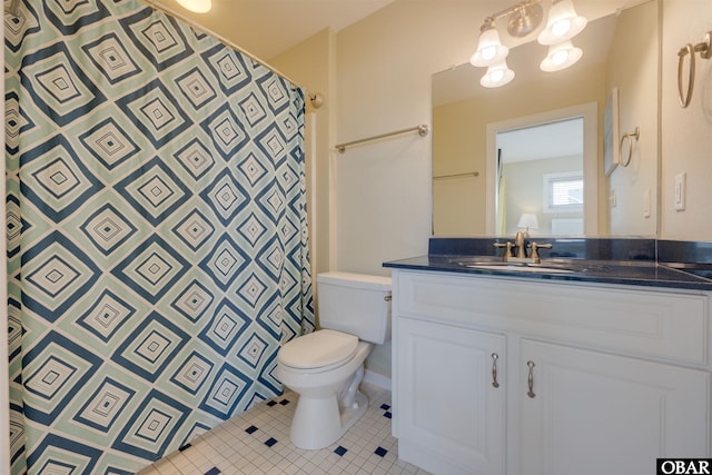 bathroom featuring tile patterned flooring, curtained shower, vanity, and toilet