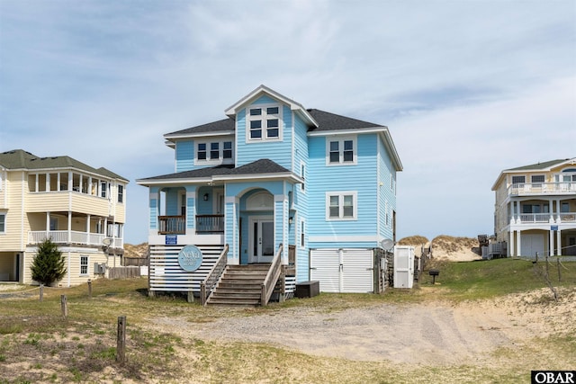 beach home with a shingled roof and cooling unit