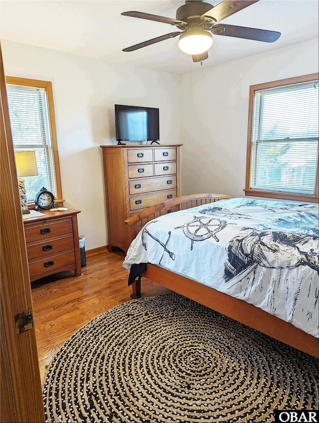 27211 Dory Rd Lot 22, Salvo, NC 27972 - bedroom featuring multiple windows, light wood-type flooring, and ceiling fan