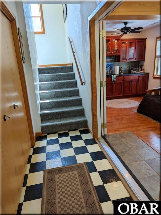27211 Dory Rd Lot 22, Salvo, NC 27972 - stairs featuring tile patterned floors, a ceiling fan, and bar area