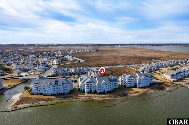 birds eye view of property with a water view and a residential view