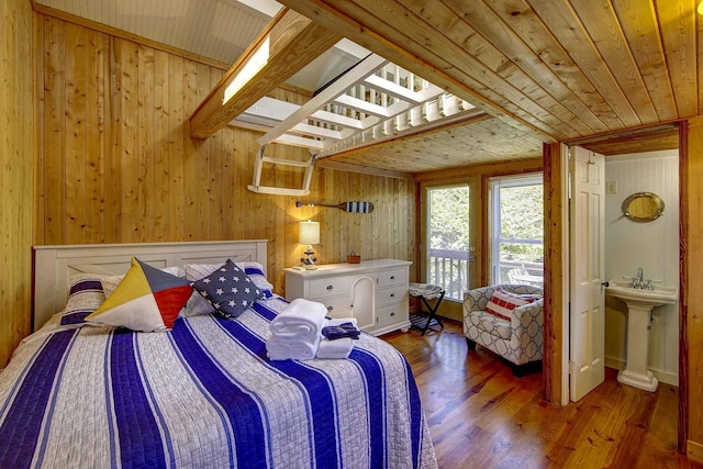 bedroom with wood-type flooring, wooden walls, a sink, and wood ceiling