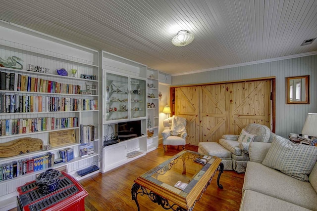 living room featuring ornamental molding, wood finished floors, and visible vents