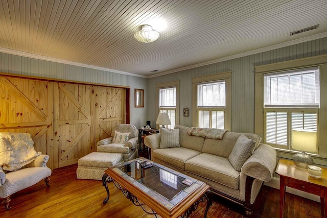 living room with ornamental molding, wood-type flooring, and visible vents