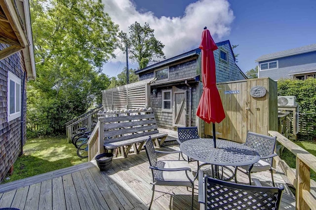 wooden deck featuring ac unit and a yard