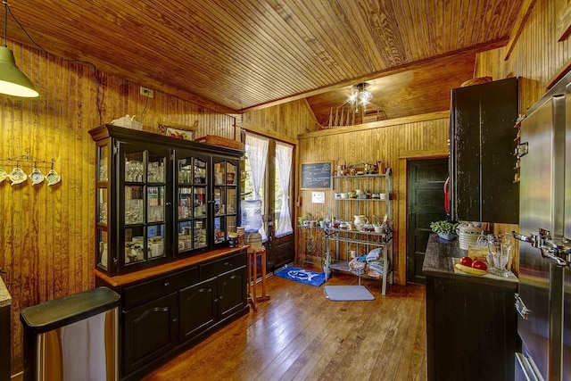 interior space featuring wooden walls, wood ceiling, and hardwood / wood-style flooring