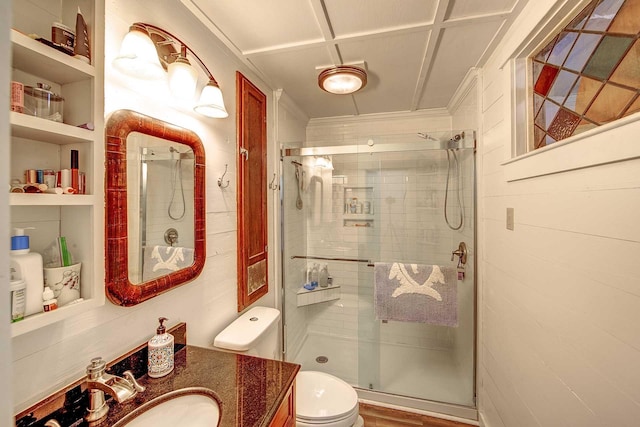 bathroom with vanity, a shower stall, toilet, and built in shelves