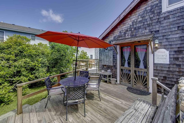 wooden deck with outdoor dining space