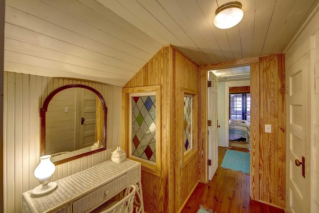 hallway featuring wood walls, wooden ceiling, hardwood / wood-style flooring, and a sauna