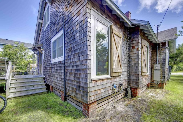 view of home's exterior with a lawn and a wooden deck