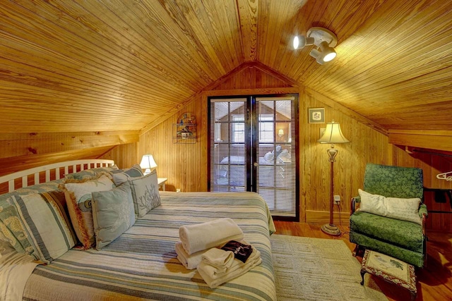 bedroom featuring wood ceiling, wood walls, wood finished floors, and lofted ceiling