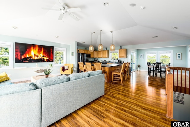 living room with recessed lighting, wood finished floors, ceiling fan, and vaulted ceiling