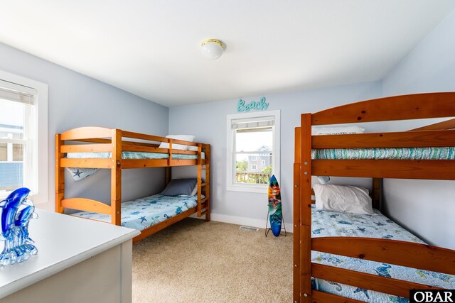 carpeted bedroom with baseboards and visible vents