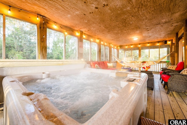 sunroom / solarium with a hot tub