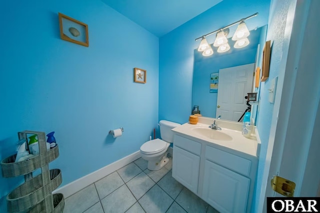 bathroom featuring vanity, toilet, tile patterned flooring, and baseboards