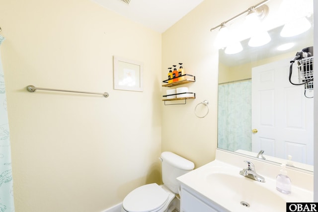 bathroom with toilet and vanity