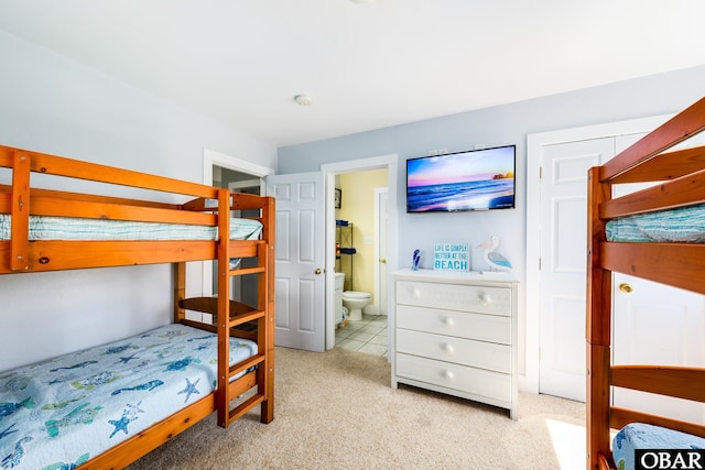 bedroom featuring carpet and ensuite bath