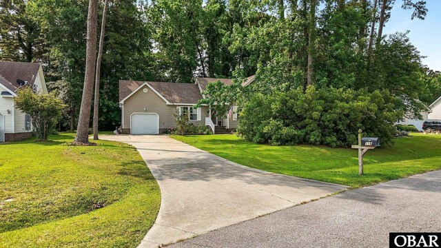116 First Colony Ct Lot 4, Manteo, NC 27954 - view of front of house with concrete driveway, an attached garage, and a front lawn