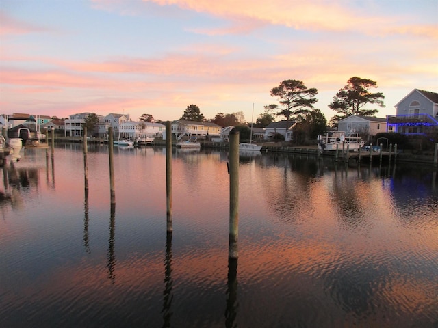 property view of water featuring a boat dock and a residential view