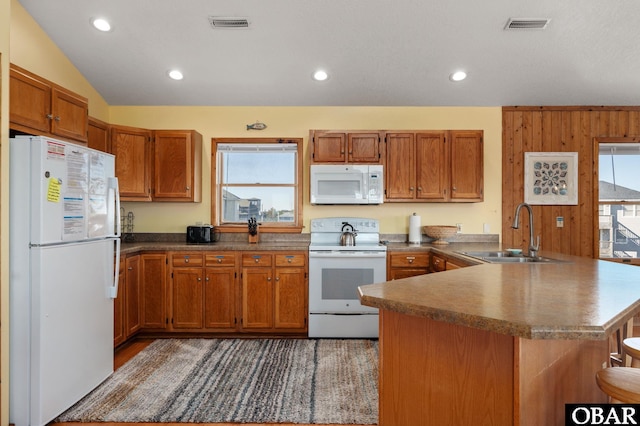 25270 Sea Isle Hills Dr Lot 5-18, Waves, NC 27982 - kitchen featuring a sink, a peninsula, a healthy amount of sunlight, and white appliances