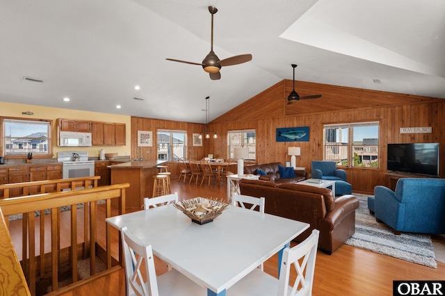 25270 Sea Isle Hills Dr Lot 5-18, Waves, NC 27982 - dining room featuring wood walls, a ceiling fan, lofted ceiling, light wood-type flooring, and visible vents