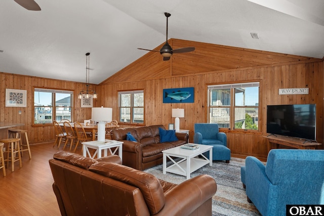 25270 Sea Isle Hills Dr Lot 5-18, Waves, NC 27982 - living room featuring wood walls, vaulted ceiling, and ceiling fan with notable chandelier