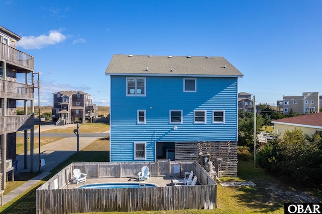 25270 Sea Isle Hills Dr Lot 5-18, Waves, NC 27982 - back of house with a fenced backyard and a fenced in pool