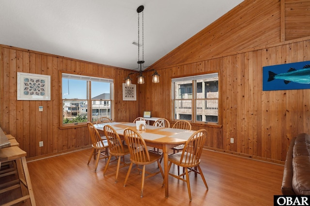 25270 Sea Isle Hills Dr Lot 5-18, Waves, NC 27982 - dining space featuring baseboards, light wood-style flooring, lofted ceiling, and wooden walls