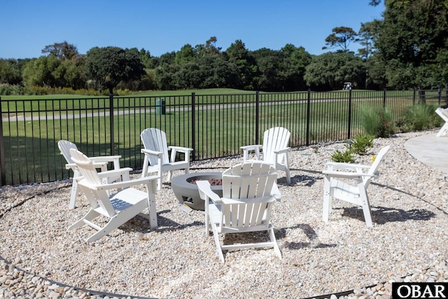 view of patio with an outdoor fire pit and fence