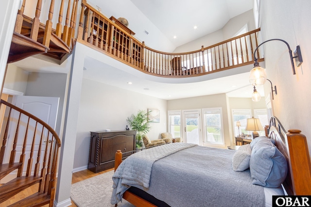 bedroom with baseboards, high vaulted ceiling, wood finished floors, and recessed lighting