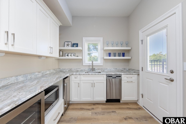 kitchen with wine cooler, open shelves, appliances with stainless steel finishes, white cabinetry, and a sink