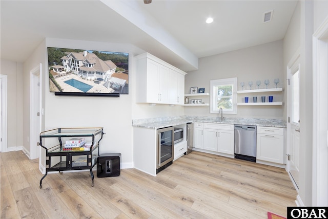 kitchen featuring open shelves, light wood finished floors, white cabinets, and stainless steel appliances